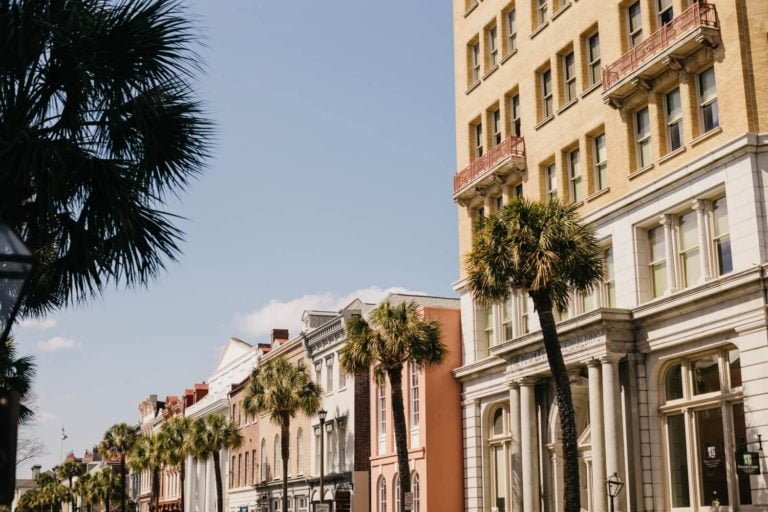 a group of palm trees in front of a building