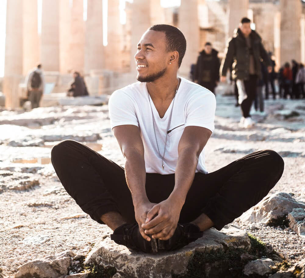 a man sitting on a rock