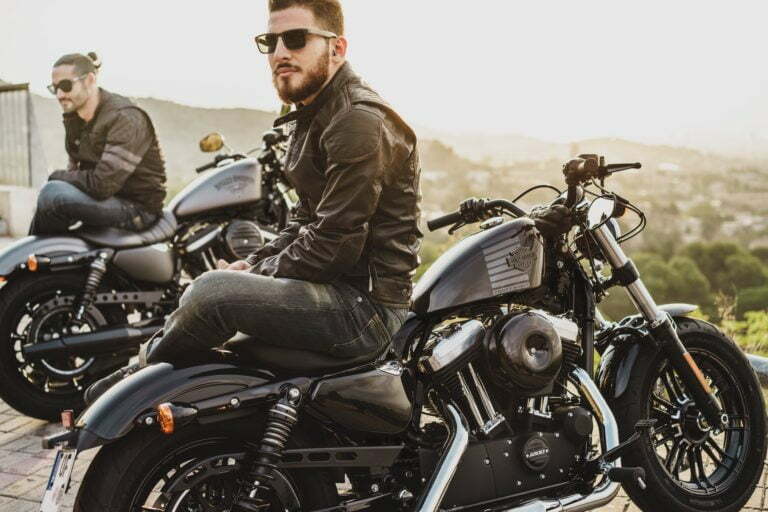 a couple of men sitting on motorcycles