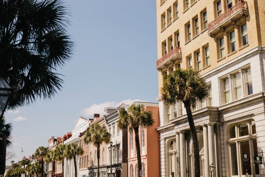 a group of palm trees in front of a building