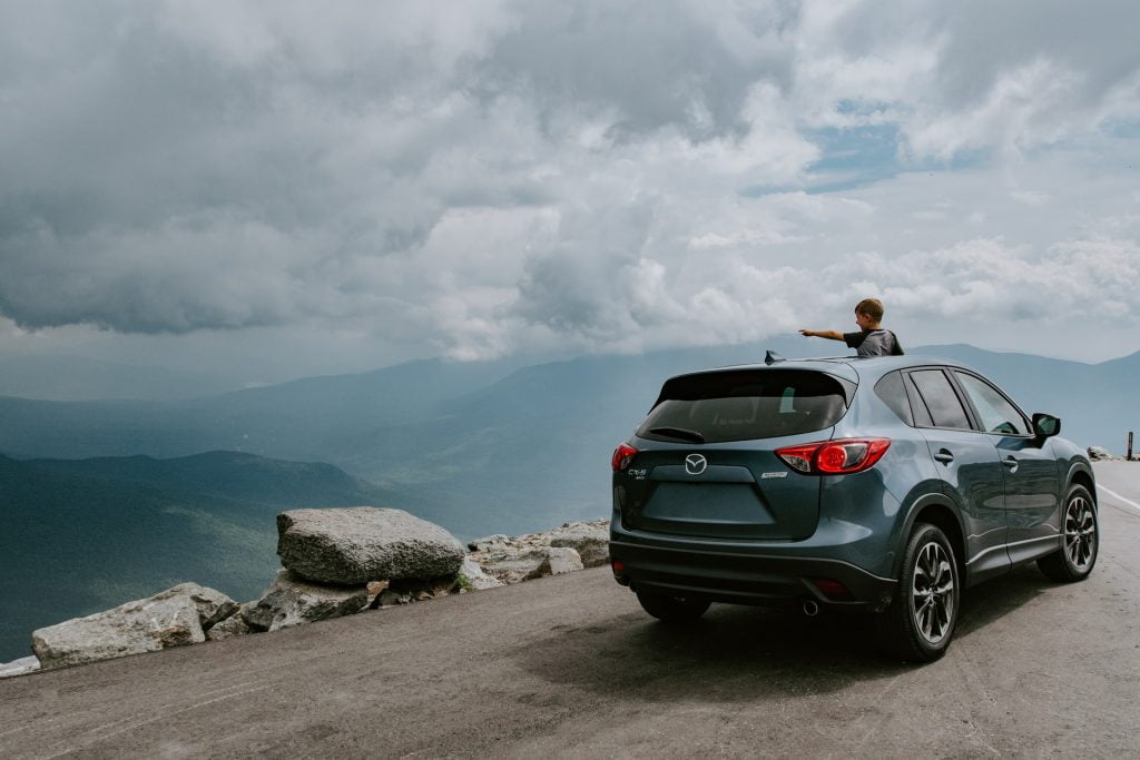 a person driving a car on a rocky road
