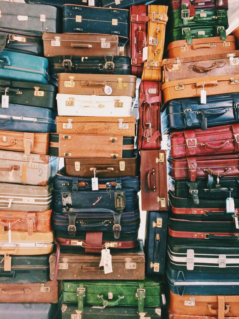 stacks of suitcases on a shelf