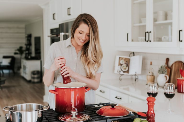 a woman cooking in a kitchen