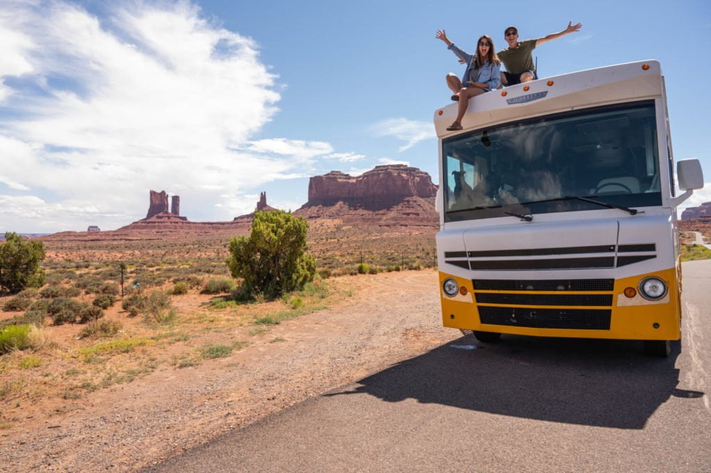 a couple of people on top of a bus