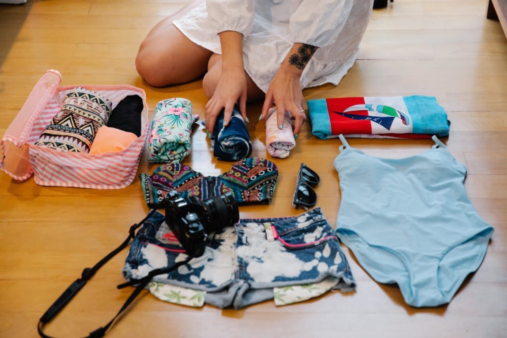 a person working on a pile of colorful patterned fabric